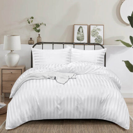 White stripe duvet cover set on hotel bed with pillows