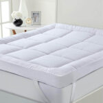 "INEQUIP quilted mattress topper with elastic corner straps for hotel use