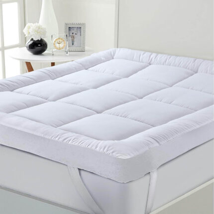 "INEQUIP quilted mattress topper with elastic corner straps for hotel use