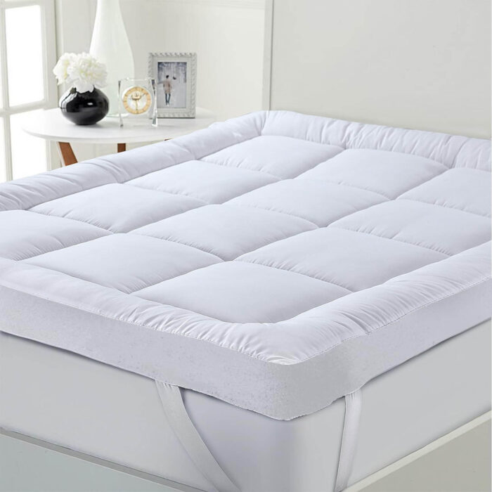 "INEQUIP quilted mattress topper with elastic corner straps for hotel use