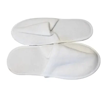 White disposable hotel slippers on bathroom floor – INEQUIP