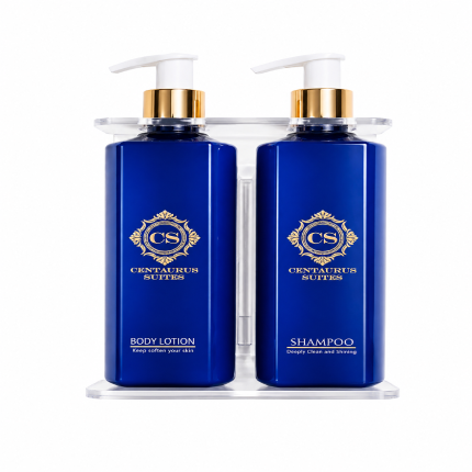 Wall-mounted bathroom liquid dispenser set with shampoo, body lotion, and hand wash bottles in a modern holder on a clean background